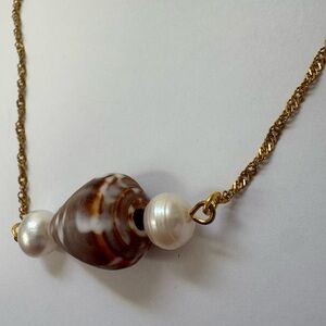 Handcrafted gold cone shell necklace with natural pearls